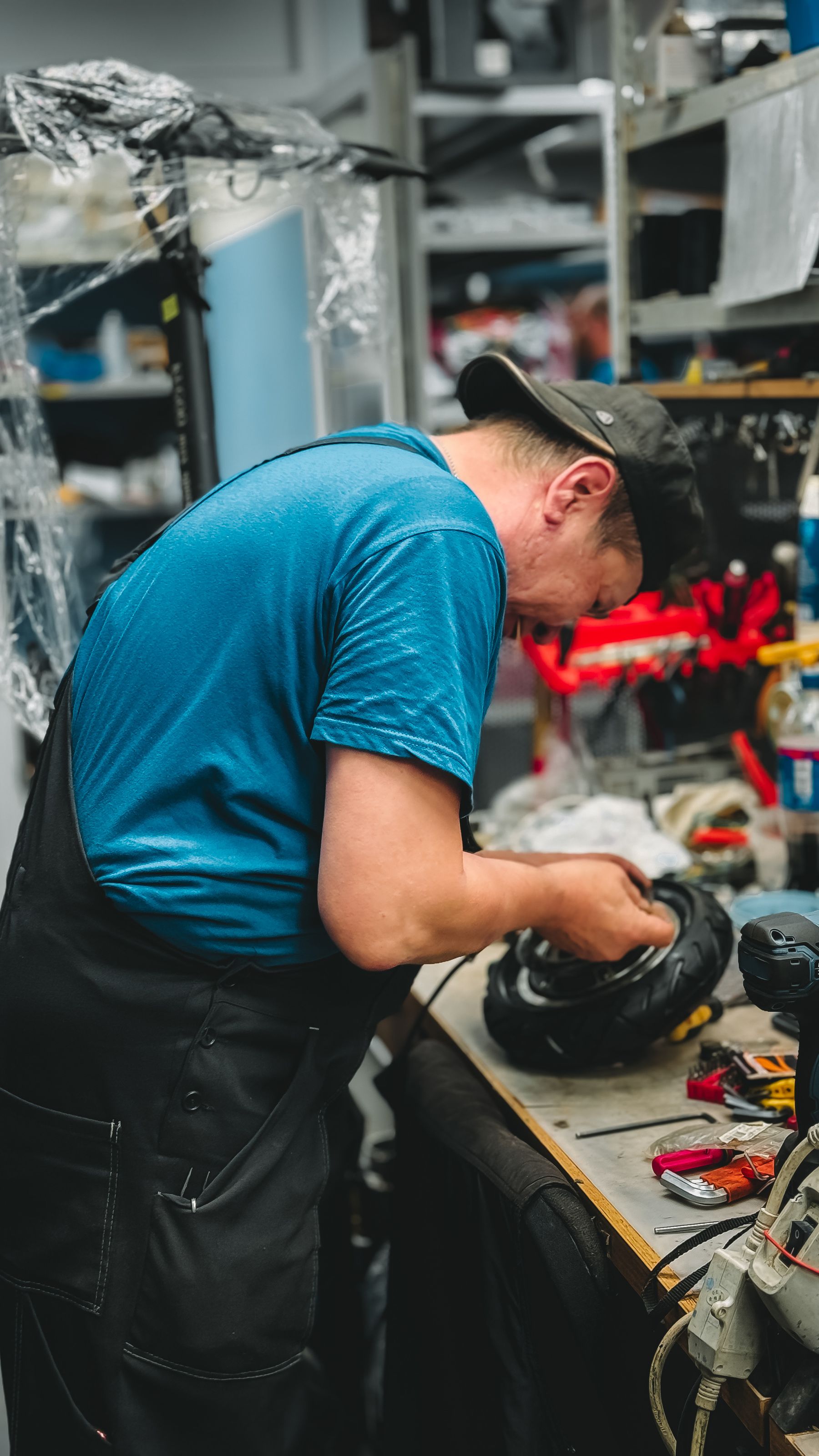 Mechanic repairing a part at a workshop bench